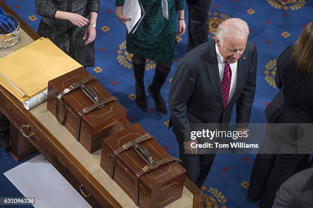 Vice President Joe Biden walks by Electoral College ballot boxes during a joint session of Congress to tally ballots for the president and vice...