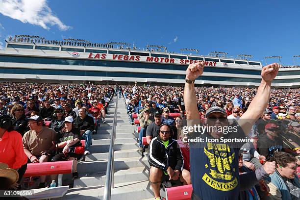 Fans enjoy themselves as they watch the race from the grandstand at LVMS during the Kobalt 400 NASCAR Sprint Cup Series race on March 6 during the at...