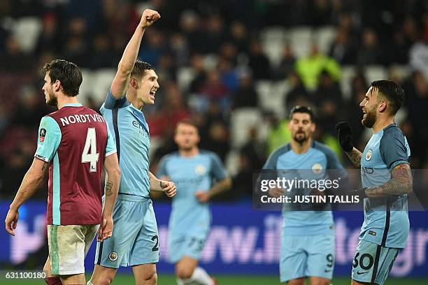 Manchester City's English defender John Stones celebrates with Manchester City's Argentinian defender Nicolas Otamendi after scoring their fifth goal...