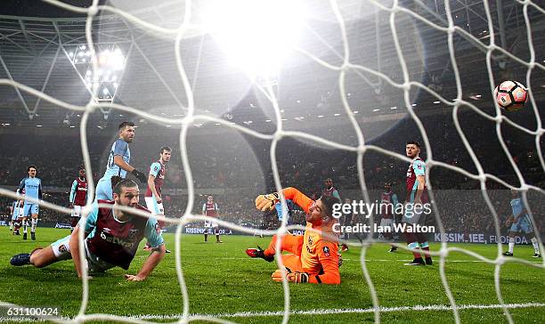 Sergio Aguero of Manchester City scores his sides fourth goal past Adrian of West Ham United during The Emirates FA Cup Third Round match between...