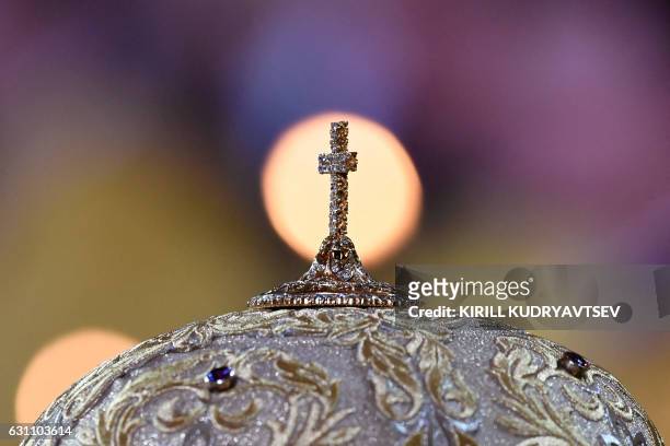 Picture taken in Moscow early on January 7, 2017 shows a detail of a Russian Orthodox priest's headdress during a Christmas service in Christ the...