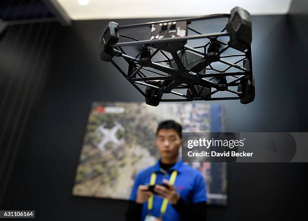 Technology representative Jinshan Yin demostrates the Rova Flying Selfie drone at CES 2017 at the Las Vegas Convention Center on January 6, 2017 in...