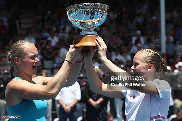 Kiki Bertens of the Netherlands and Johanna Larsson of Sweden hold the trophy after winning the womens doubles final against Demi Schuurs of the...