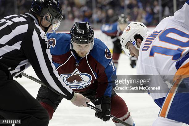 John Mitchell of the Colorado Avalanche eyes the puck as he takes a face off against Alan Quine of the New York Islanders during the first period at...