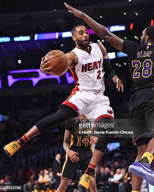 Tarik Black of the Los Angeles Lakers reaches out to defend a pass by Wayne Ellington of the Miami Heat in the first half of the game at Staples...
