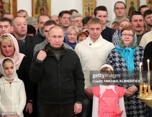 Russian President Vladimir Putin attends a Christmas service at the Saint George's Monastery in Novgorod Region early on January 7, 2017. - Orthodox...