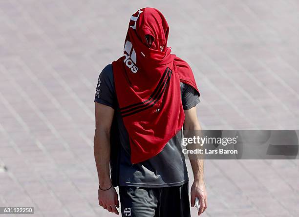 Franck Ribery hides under a jacket after a training session at day 5 of the Bayern Muenchen training camp at Aspire Academy on January 7, 2017 in...