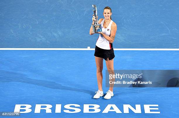 Karolina Pliskova of the Czech Republic celebrates victory as she holds up the winners trophy after her match against Alize Cornet of France during...