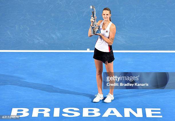 Karolina Pliskova of the Czech Republic celebrates victory as she holds up the winners trophy after her match against Alize Cornet of France during...
