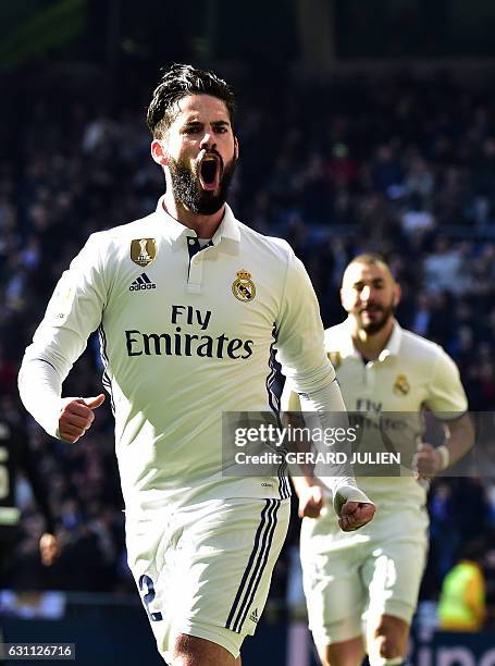 Real Madrid's midfielder Isco celebrates after scoring during the Spanish league football match Real Madrid CF vs Granada FC at the Santiago Bernabeu...