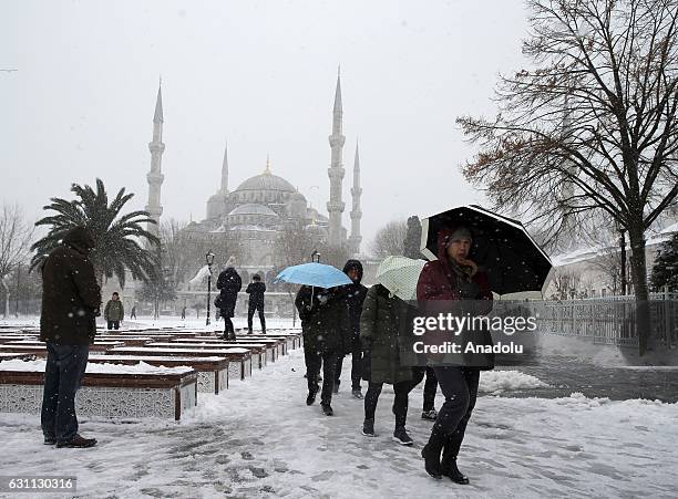 People ares seen at the Sultanahmet Square as the historical Sultanahmet Mosque, also known as Blue Mosque, is seen at the background during a...