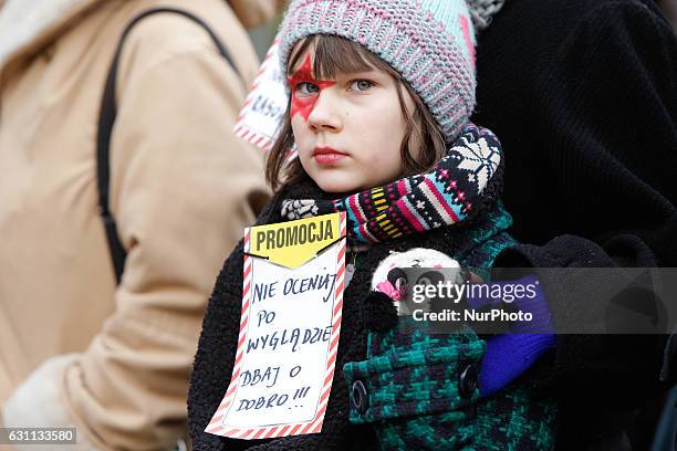 People are seen at a rally against racial violence in Poznan on 7 January, 2017. Kika, a young girl is seen at the rally speaking about her Ukrainian...