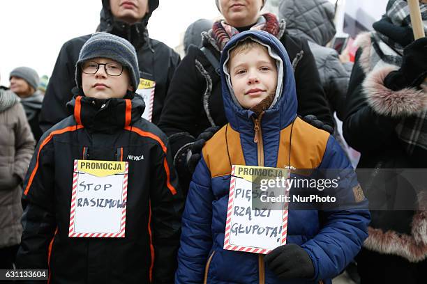 People are seen at a rally against racial violence in Poznan on 7 January, 2017. Children holding signs with stop racism and the fist is ruled by...
