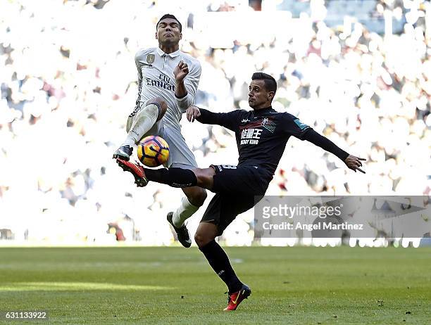 Caseiro of Real Madrid competes for the ball with Javier Marquez of Granada during the La Liga match between Real Madrid and Granada CF on January 7,...