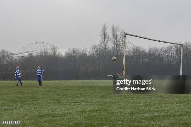 Young footballers play football behind the DW Stadium before the Emirates FA Cup Third Round match between Wigan Athletic and Nottingham Forest on...