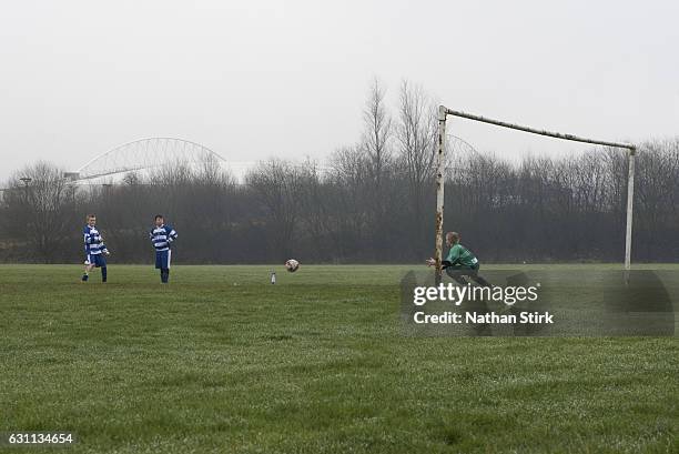 Young footballers play football behind the DW Stadium before the Emirates FA Cup Third Round match between Wigan Athletic and Nottingham Forest on...