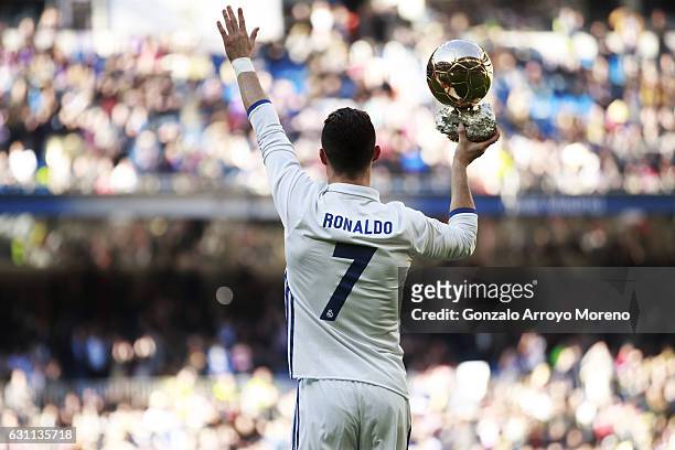 Cristiano Ronaldo of Real Madrid CF shows his fourth Golden Ball to the audience prior to start the La Liga match between Real Madrid CF and Granada...