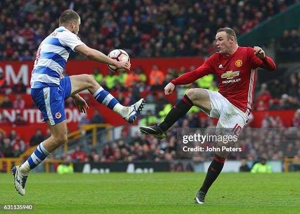 Wayne Rooney of Manchester United in action with Joey van den Berg of Reading during the Emirates FA Cup Third Round match between Manchester United...