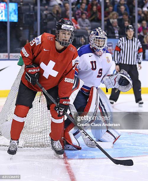 Tyler Parsons of Team USA protects the corner with Nico Hischier of Team Switzerland on his doorstep during a QuarterFinal game at the 2017 IIHF...