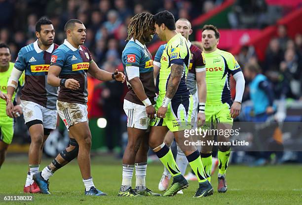 Marland Yarde of Harlequins confronts Denny Solomona of Sale Sharks, after a tackle which left team mate Nick Evans of Harlequins not playing any...