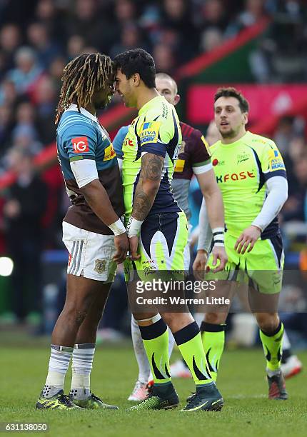 Marland Yarde of Harlequins confronts Denny Solomona of Sale Sharks, after a tackle which left team mate Nick Evans of Harlequins not playing any...