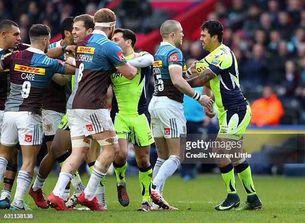 Mike Brown of Harlequins confronts Denny Solomona of Sale Sharks, after a tackle which left team mate Nick Evans of Harlequins not playing any futher...