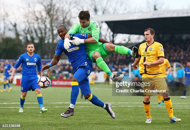 Tom Elliott of AFC Wimbledon and Ross Worner of Sutton United clash during The Emirates FA Cup Third Round match between Sutton United and AFC...