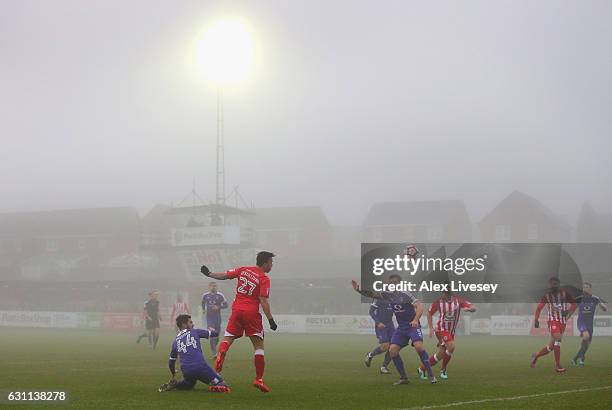 John O'Sullivan of Accrington Stanley heads the ball across the Luton Town penalty area as fog descends during the Emirates FA Cup Third Round match...