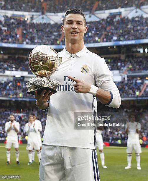 Cristiano Ronaldo of Real Madrid CF shows his fourth Golden Ball to the audience prior to start the La Liga match between Real Madrid CF and Granada...