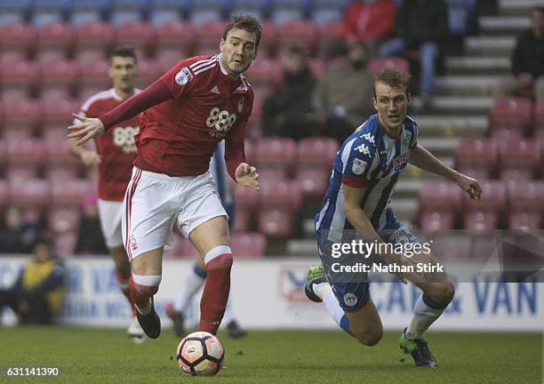 Nicklas Bendtner of Nottingham Forest and Dan Burn of Wigan Athletic in action during the Emirates FA Cup Third Round match between Wigan Athletic...