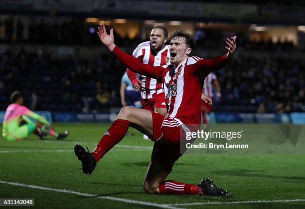 Dan Scarr of Stourbridge celebrates scoring his sides first goal during the Emirates FA Cup Third Round match between Wycombe Wanderers and...