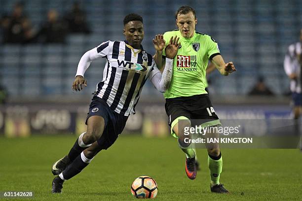 Millwall's English midfielder Fred Onyedinma vies with Bournemouth's Australian midfielder Brad Smith during the English FA Cup third round football...