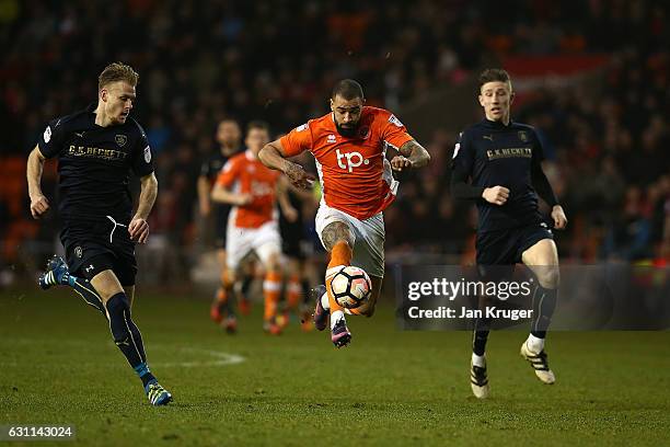 Kyle Vassell of Blackpool controls the ball under pressure from Marc Roberts and Angus MacDonald of Barnsley during The Emirates FA Cup Third Round...