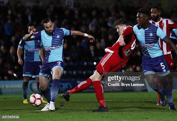 Dan Scarr of Stourbridge scores his sides first goal during the Emirates FA Cup Third Round match between Wycombe Wanderers and Stourbridge at Adams...