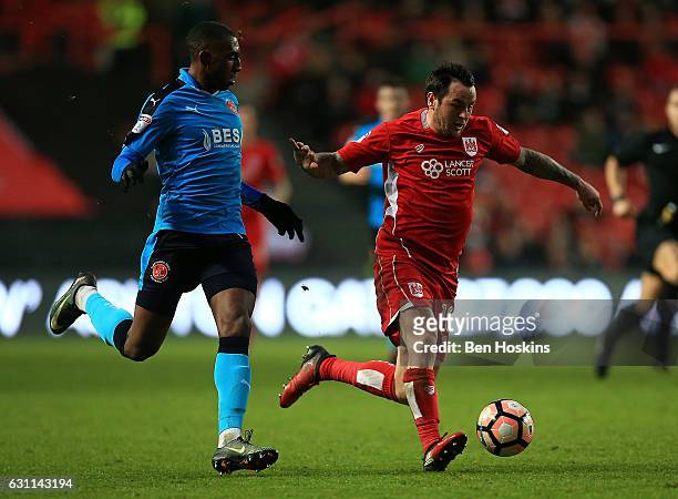 Lee Tomlin of Bristol holds off pressure from Amarii Bell of Fleetwood during The Emirates FA Cup Third Round match between Bristol City and...