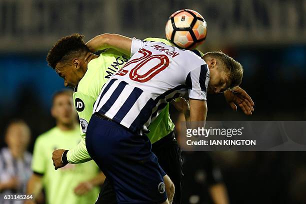 Bournemouth's English defender Tyrone Mings vies with Millwall's English-born Welsh striker Steve Morison during the English FA Cup third round...