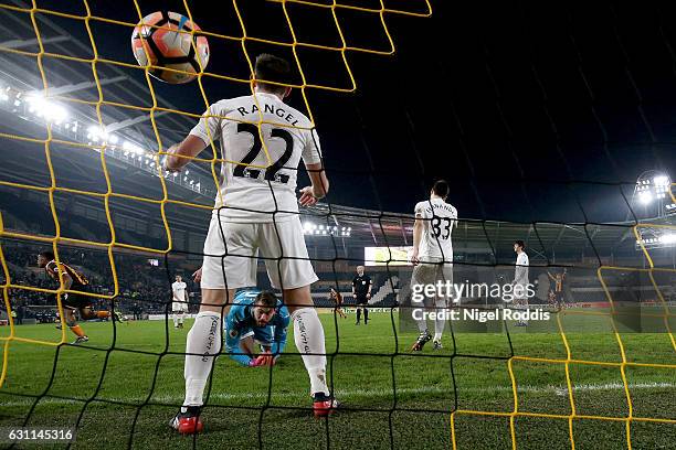 Angel Rangel of Swansea City attempts to stop as Abel Hernandez of Hull City scores his sides first goal during the Emirates FA Cup third round match...