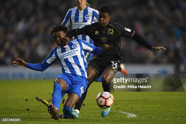 Sam Adekugbe of Brighton challenges Kieran Agard of MK Dons during The Emirates FA Cup Third Round match between Brighton & Hove Albion and Milton...