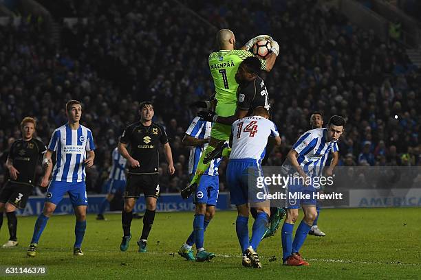Niki Maenpaa of Brighton clatters into Chuks Aneke of MK Dons during The Emirates FA Cup Third Round match between Brighton & Hove Albion and Milton...