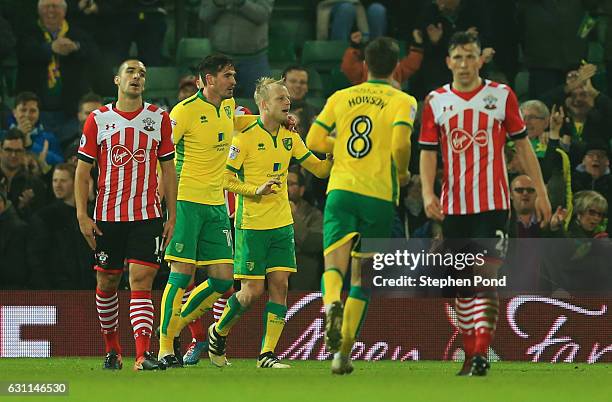 Steven Naismith of Norwich City celebrates with team mates after scoring his sides second goal during the Emirates FA Cup Third Round match between...