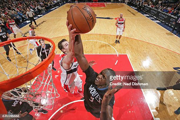 Jason Smith of the Washington Wizards goes up for a rebound against Gorgui Dieng of the Minnesota Timberwolveson on January 6, 2017 at Verizon Center...