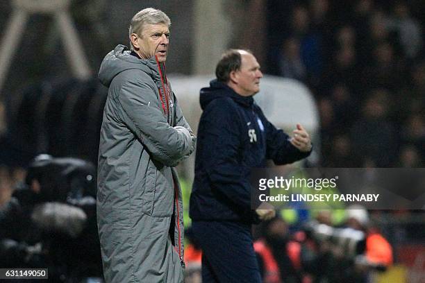 Arsenal's French manager Arsene Wenger and Preston's English manager Simon Grayson watch from the touchline during the English FA Cup third round...