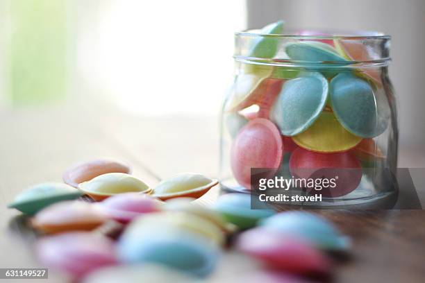 jar of pastel colored flying saucer sweets - sweet jar stock pictures, royalty-free photos & images