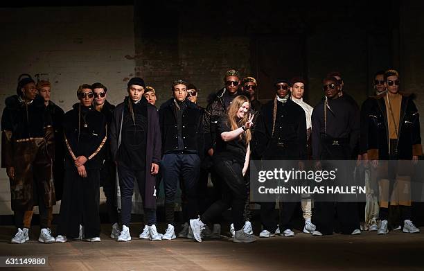 Danish born fashion designer Astrid Andersen greets the crowd after showcasing her collection the second day of the Autumn/Winter 2017 London Fashion...