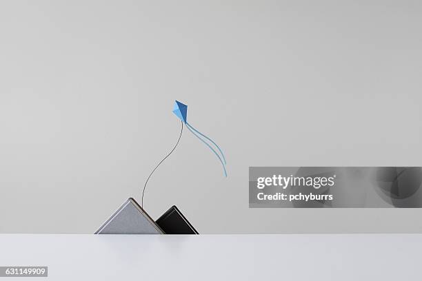 conceptual papermade mountain range and kite - kite toy stock pictures, royalty-free photos & images