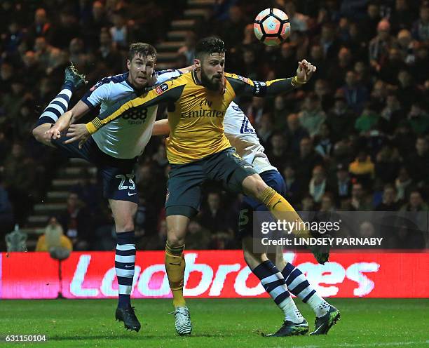 Arsenal's French striker Olivier Giroud vies with Preston's English defender Paul Huntington during the English FA Cup third round football match...