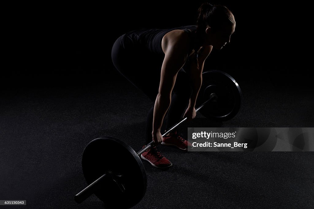 Women lifting a barbell in the gym