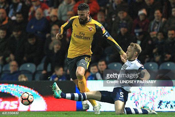Arsenal's French striker Olivier Giroud vies with Preston's English defender Tom Clarke during the English FA Cup third round football match between...