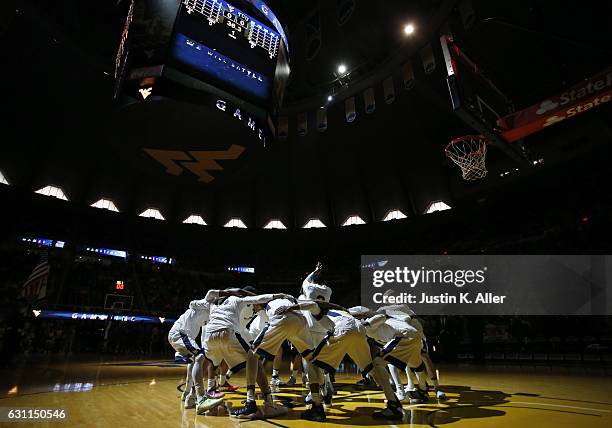 The West Virginia Mountaineers huddle before the game against the TCU Horned Frogs at the WVU Coliseum on January 7, 2017 in Morgantown, West...