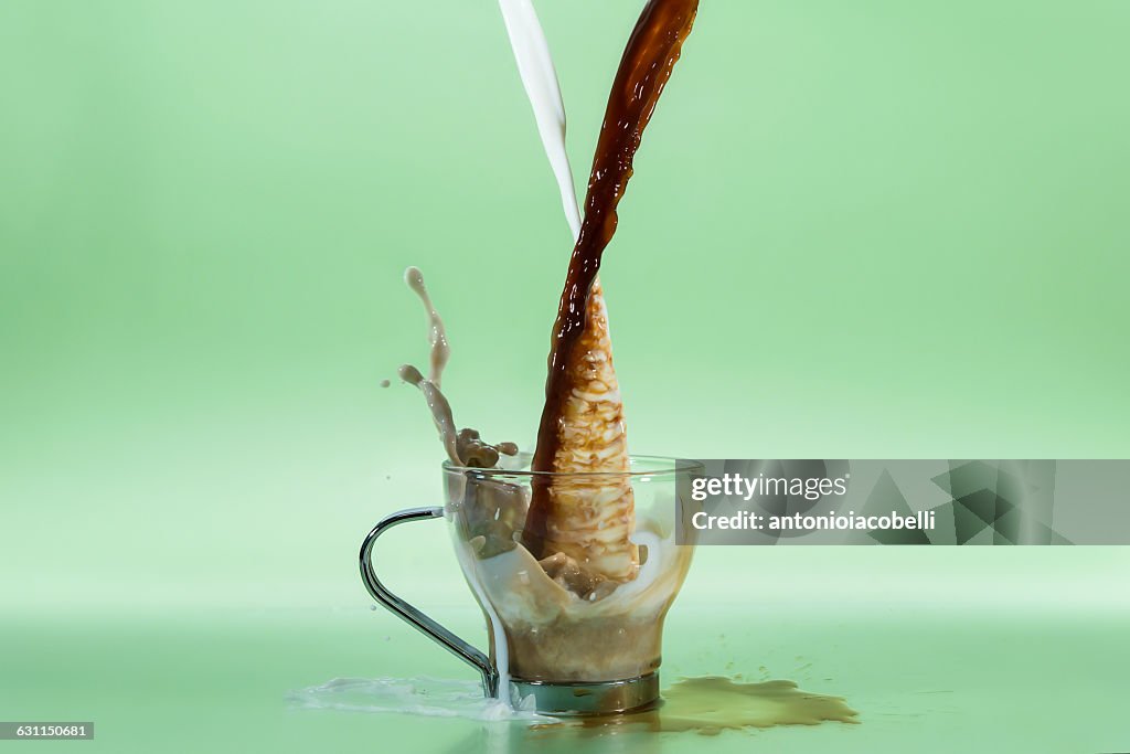 Milk & Coffee being poured into a cup